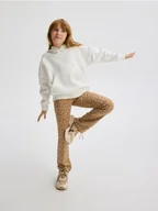 Spodnie i spodenki dla dziewczynek - Reserved - Wzorzyste spodnie flare - beżowy - miniaturka - grafika 1