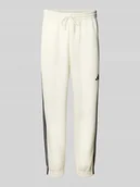 Spodnie sportowe męskie - Spodnie dresowe o kroju relaxed fit z wyhaftowanym logo model ‘Stadium’ - miniaturka - grafika 1