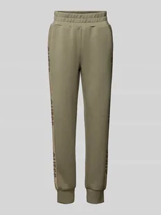 Spodnie dresowe o kroju slim fit z nadrukami z logo - Spodnie sportowe damskie - miniaturka - grafika 1