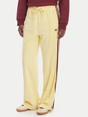 Spodnie sportowe damskie - adidas Spodnie dresowe Terry Towel Firebird KQ6662 Żółty Loose Fit - miniaturka - grafika 1