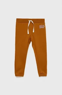 Spodnie i spodenki dla dziewczynek - GAP spodnie dresowe dziecięce kolor pomarańczowy z nadrukiem - Gap - grafika 1