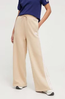 Spodnie damskie - adidas spodnie dresowe kolor beżowy z aplikacją - grafika 1