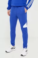 Spodnie męskie - adidas spodnie dresowe kolor niebieski z nadrukiem - miniaturka - grafika 1