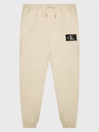 Spodnie i spodenki dla dziewczynek - Calvin Klein Jeans Spodnie dresowe IB0IB01505 Beżowy Regular Fit - miniaturka - grafika 1