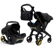 Foteliki samochodowe - Doona Mobilny fotelik baza isofix 0-13kg Just Black - miniaturka - grafika 1