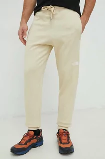 Spodnie męskie - The North Face spodnie dresowe bawełniane męskie kolor beżowy gładkie - grafika 1