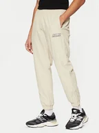 Spodnie sportowe męskie - Karl Kani Spodnie dresowe Sport Patch Essential 60030075 Beżowy Relaxed Fit - miniaturka - grafika 1