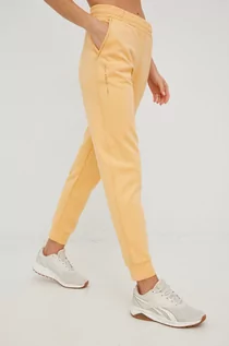 Spodnie damskie - Outhorn spodnie dresowe damskie kolor żółty gładkie - grafika 1