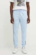 Spodnie męskie - adidas Originals spodnie dresowe Adicolor Classics SST Track Pants kolor niebieski z aplikacją IY8730 - miniaturka - grafika 1
