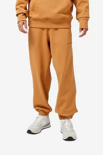 Spodnie męskie - New Balance spodnie dresowe bawełniane kolor pomarańczowy gładkie (puste) - grafika 1