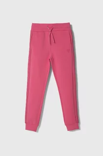 Spodnie i spodenki dla dziewczynek - Guess spodnie dresowe dziecięce kolor różowy gładkie - grafika 1