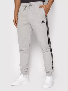 Spodnie sportowe męskie - Adidas Spodnie dresowe Essentials 3-Stripes GM1091 Szary Slim Fit - grafika 1