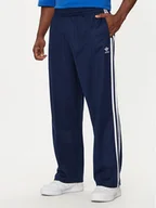 Spodnie sportowe męskie - adidas Spodnie dresowe adicolor Firebird IZ2466 Granatowy Baggy Fit - miniaturka - grafika 1