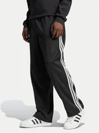 Spodnie sportowe męskie - adidas Spodnie dresowe adicolor Firebird IZ4801 Czarny Baggy Fit - miniaturka - grafika 1