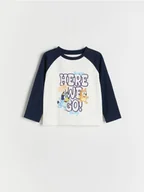 Bluzki dla niemowląt - Reserved - Bawełniany longsleeve Bluey - złamana biel - miniaturka - grafika 1