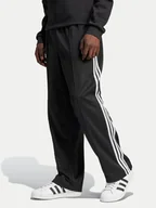 Spodnie sportowe męskie - adidas Spodnie dresowe adicolor Firebird IZ4801 Czarny Baggy Fit - miniaturka - grafika 1