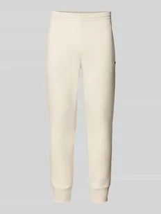 Spodnie dresowe o kroju slim fit z naszywką z logo - Spodnie sportowe męskie - miniaturka - grafika 1