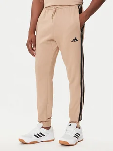 adidas Spodnie dresowe Essentials 3-Stripes JX0712 Beżowy Regular Fit - Spodnie sportowe męskie - miniaturka - grafika 1