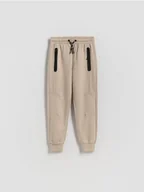 Spodnie i spodenki dla chłopców - Reserved - Bawełniane spodnie jogger - beżowy - miniaturka - grafika 1