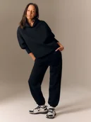 Bluzy damskie - 4F Bluza dresowa loose z kapturem damska - czarna XS - miniaturka - grafika 1