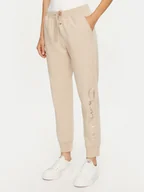 Spodnie sportowe damskie - Champion Spodnie dresowe 117584 Beżowy Slim Fit - miniaturka - grafika 1