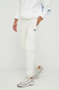 Spodnie męskie - Reebok Classic spodnie dresowe męskie kolor beżowy z nadrukiem - grafika 1