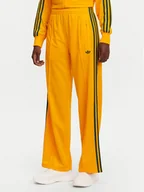 Spodnie sportowe damskie - adidas Spodnie dresowe adicolor Classic Firebird JP2316 Żółty Loose Fit - miniaturka - grafika 1