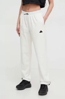 Spodnie damskie - adidas spodnie dresowe kolor beżowy - grafika 1
