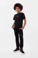 Spodnie i spodenki dla dziewczynek - Dkny spodnie dresowe bawełniane dziecięce kolor czarny z nadrukiem - DKNY - miniaturka - grafika 1