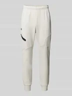 Spodnie sportowe męskie - Spodnie dresowe o kroju relaxed fit z nadrukiem z logo model ‘Unstoppable’ - miniaturka - grafika 1