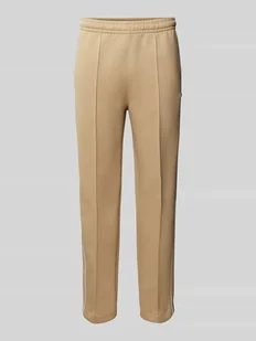 Spodnie dresowe o kroju slim fit z naszywką z logo - Spodnie sportowe męskie - miniaturka - grafika 1