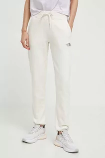 Spodnie damskie - The North Face spodnie dresowe bawełniane kolor beżowy z nadrukiem NF0A87DMQLI1 - grafika 1