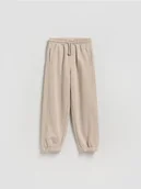 Spodnie i spodenki dla chłopców - Reserved - Bawełniane spodnie jogger - kremowy - miniaturka - grafika 1