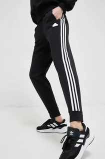 Spodnie damskie - adidas spodnie dresowe kolor czarny z aplikacją - grafika 1