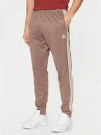 Spodnie sportowe męskie - adidas Spodnie dresowe adicolor Classics SST JP2518 Beżowy Slim Fit - miniaturka - grafika 1