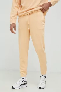 Spodnie męskie - Outhorn spodnie dresowe męskie kolor pomarańczowy z aplikacją - grafika 1