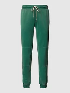 Spodnie sportowe męskie - Spodnie dresowe o kroju standard fit z elastycznym pasem i szwami działowymi - grafika 1