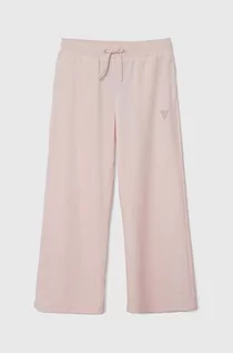 Spodnie i spodenki dla dziewczynek - Guess spodnie dresowe welurowe dziecięce kolor różowy gładkie - grafika 1