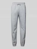 Spodnie sportowe męskie - Spodnie dresowe o kroju regular tapered fit z nadrukiem z logo - miniaturka - grafika 1