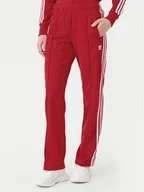 Spodnie sportowe damskie - adidas Spodnie dresowe adicolor Classics Firebird IR8081 Czerwony Regular Fit - miniaturka - grafika 1