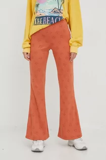 Spodnie damskie - Billabong spodnie damskie kolor pomarańczowy dzwony medium waist - grafika 1