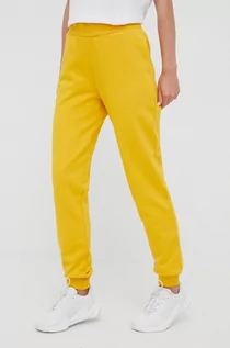 Spodnie damskie - Jack Wolfskin spodnie dresowe bawełniane damskie kolor żółty gładkie - grafika 1