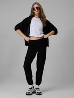 Spodnie sportowe damskie - 4F Spodnie dresowe joggery damskie - czarne XL - miniaturka - grafika 1