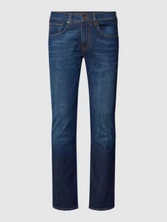 Spodnie męskie - Jeansy z niskim stanem i szwami w kontrastowym kolorze - grafika 1