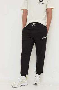 Spodnie męskie - DC spodnie dresowe kolor czarny z aplikacją - grafika 1