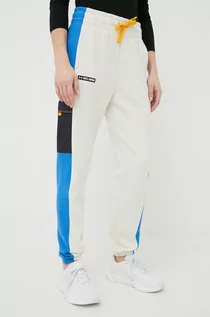 Spodnie damskie - Under Armour spodnie dresowe damskie kolor beżowy wzorzyste - grafika 1