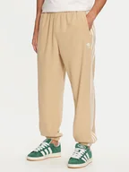 Spodnie sportowe męskie - adidas Spodnie dresowe adicolor 3-Stripes IZ2490 Beżowy Regular Fit - miniaturka - grafika 1