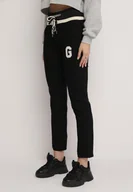 Spodnie damskie - Czarne Spodnie z Szeroką Gumką w Pasie i Naszywką na Nogawce Kuian - miniaturka - grafika 1