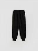 Spodnie i spodenki dla chłopców - Reserved - Bawełniane spodnie jogger - czarny - miniaturka - grafika 1