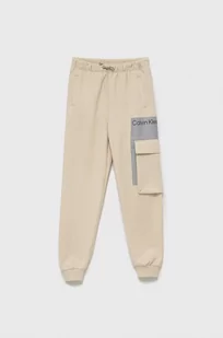 Calvin Klein Jeans Spodnie dziecięce kolor beżowy z nadrukiem - Spodnie damskie - miniaturka - grafika 1